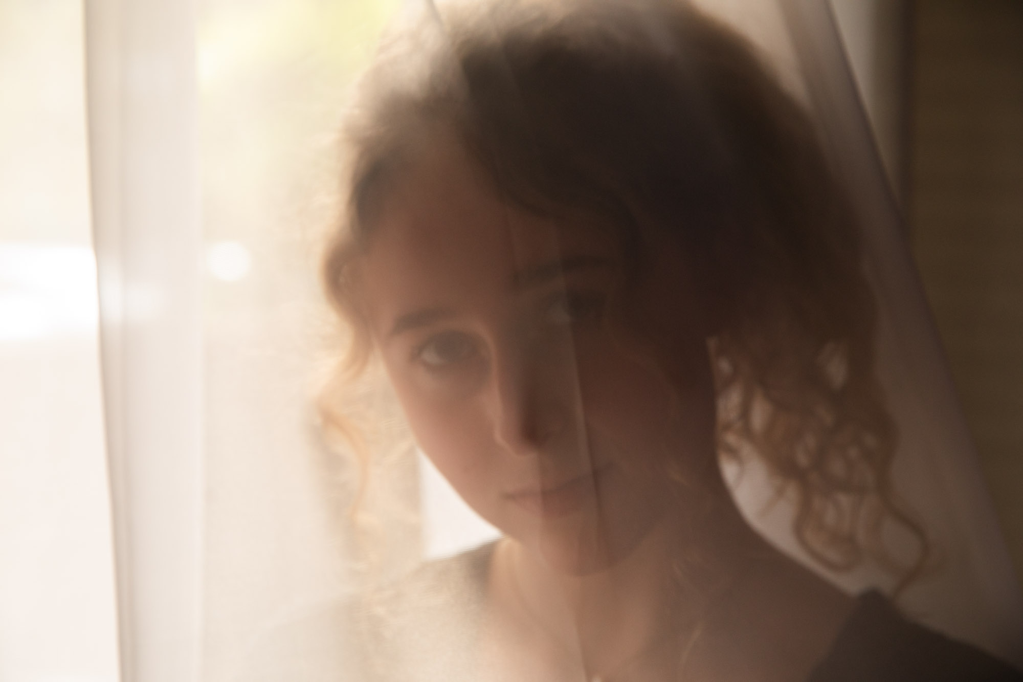 Lucia Smith behind curtain